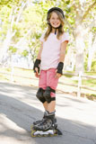 Young+girl+outdoors+on+inline+skates+smiling