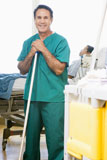 An+Orderly+Mopping+The+Floor+In+A+Hospital+Ward