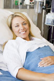 %22Woman+Smiling%2CLying+In+Hospital+Bed%22