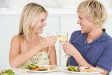 %22Young+Couple+Enjoying+meal%2Cmealtime+With+A+Glass+Of+Wine%22