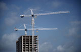 Low+angle+view+of+a+crane+at+a+construction+site
