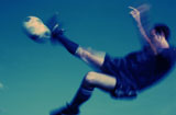 Soccer+player+in+mid-air+kicking+a+soccer+ball