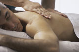 Close-up+of+a+mid+adult+man+getting+a+back+massage+from+a+massage+therapist