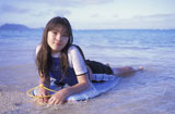 Portrait+of+a+teenage+girl+lying+on+a+bodyboard+on+the+beach