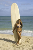 Young+woman+standing+with+a+surfboard