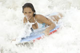 Close-up+of+a+young+woman+surfing+with+a+surfboard