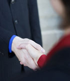 Businessman+and+businesswoman+give+each+other+a+handshake
