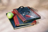 Granny+Smith+apple+with+a+pen+and+eyeglasses+on+books