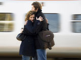 Young+couple+embracing+each+other+at+a+railroad+station+platform