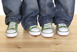 pair+of+green+sneakers+for+children+on+the+floor