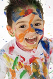 Happy+3+year+old+boy+covered+in+paint.