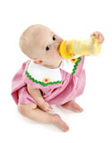 Adorable+baby+girl+barefoot+on+white+drinking+from+big+yellow+bottle.