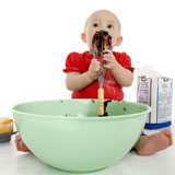 Adorable+baby+girl+eating+chocolate+cake+batter+off+whisk.