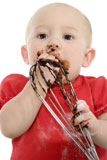 Adorable+baby+girl+licking+the+mixer+full+of+chocolate+batter.+Covered+in+flour.
