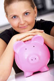 beautiful+business+woman+with+a+piggy+bank+at+home