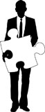 A+silhouette+of+a+businessman+holding+a+piece+of+jigsaw+ready+for+you+to+add+your+own+text