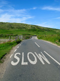 Slow+sign+on+an+English+countryside+road.
