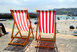 Two+empty+deckchairs+on+the+sea+front%2C+St.+Ives%2C+UK.