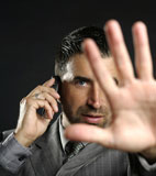 Angry+businessman+saying+stop+with+hand%2Ctalking+to+a+mobile+phone