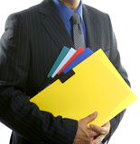 Businessman+and+color+folders+over+white%2C+yellow%2C+studio+with+no+face