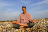 young+man+at+the+beach+in+meditation+