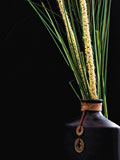 Oriental+Vase+with+assorted+grasses+on+a+black+background.+