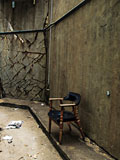 Lone+chair+in+an+abandoned+building.+