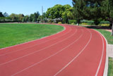Athletic+Track+Curving+Around+Green+Grass+Field+