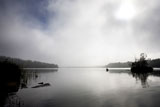 A+peaceful+lake+with+calm+fog+