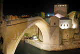 Old+Bridge+in+Mostar+at+night+reconstructed+in+2003+after+the+original+from+1556.+