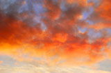Orange+clouds+at+sunset+contrasting+the+blue+sky.+