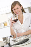 Women+in+kitchen+with+glass+of+wine+