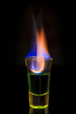 Green+absinth+drink+on+fire+over+black+background+