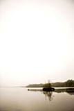 A+peaceful+lake+with+calm+fog+