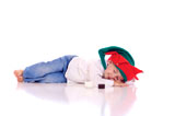 Cute+little+boy+with+a+christmas+hat+lying+on+the+floor+