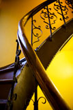 An+abstract+image+of+an+old+stairwell+and+railing+with+decorative+iron.+