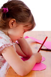 Cute+little+girl+drawing+on+a+pink+heart+