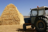Barn+stacked+with+piramyd+shape+and+agriculture+tractor+vehicle