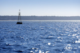 Beacon+floating+on+blue+ocean+as+navigation+guide+help