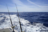 Fishing+on+the+boat+with+trolling+rod+and+reel.+Blue+Mediterranean+sea.