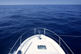 Bow+of+yacht+white+boat+cruing+the+blue+ocean+water+in+Mediterranean+sea
