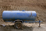 Blue+water+container+trailer+to+wet+soil+in+roads+contruction