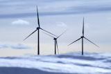 aerogenerator+electric+windmills+snow+mountain+blurred+foreground