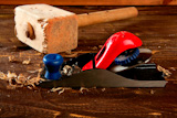 planer+carpenter+hand+tool+wood+shaving+over+wooden+board