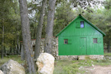 Green+little+wooden+house+in+a+Mediterranean+forest