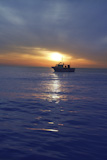 sunset+sunrise+with+fishing+boat+in+horizon+blue+mediterranean+sea