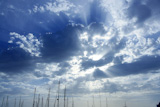 Cloudy+sunset+beam+sky+with+marina+sailboat+masts+on+bottom