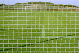 Net+soccer+goal+football+green+grass+field+sunny+day+outdoors+