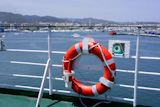 Cruise+white+boat+handrail+in+blue+Ibiza+sea+and+round+orange+buoy