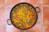 Paella+rice+recipe+Mediterranean+Spain+round+pan+on+clay+floor
